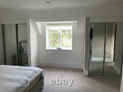 2 CLASSIC double wardrobes each with 2 sliding mirrored doors -one year old