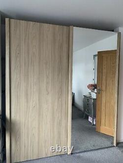 Large Oak Effect And Mirror Sliding Door Wardrobes