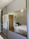 Large grey mirrored wardrobe with sliding doors, purchased from Bensons and Beds