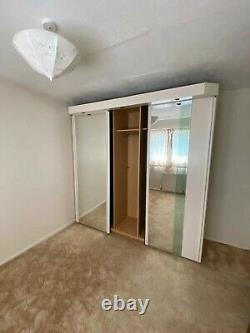 Triple mirror sliding doors wardrobe with built-in spotlights