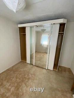 Triple mirror sliding doors wardrobe with built-in spotlights